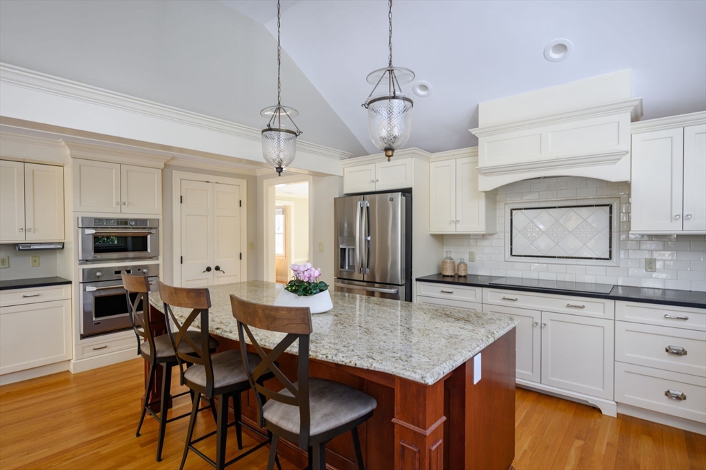 7 Village Lane Hingham, MA 02043 - Photo 7 of 34 a kitchen with a table chairs stove and microwave