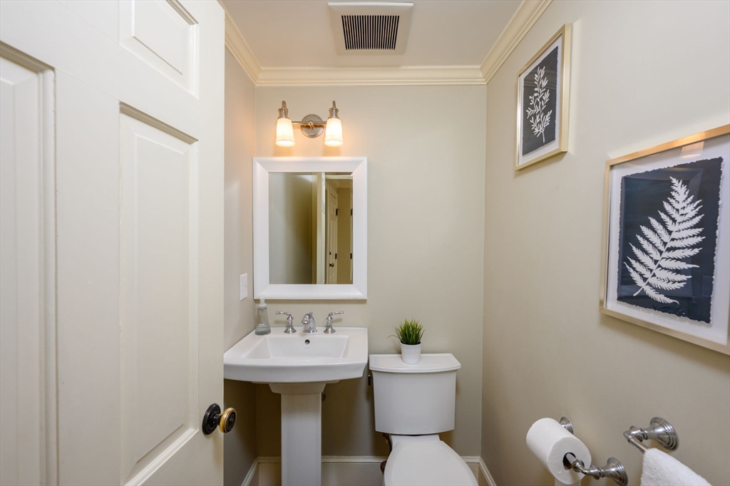 7 Village Lane Hingham, MA 02043 - Photo 10 of 34 a bathroom with a toilet a sink and mirror