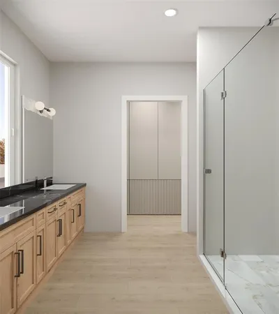 a bathroom with a granite countertop sink a mirror and a shower