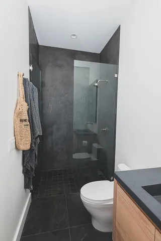 a kitchen with granite countertop lots of clutter and cabinets