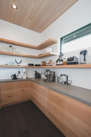 a view of a house with big yard and large trees