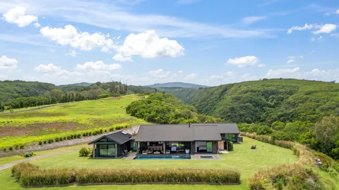 a spacious bedroom with a bed and a dresser