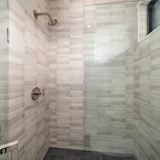 a view of living room kitchen with stainless steel appliances cabinets