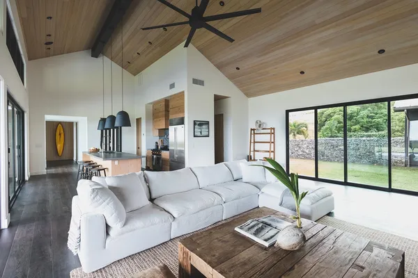 a living room with stainless steel appliances kitchen island granite countertop a stove a sink and a microwave