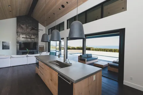 a kitchen with a table chairs and a stove in it