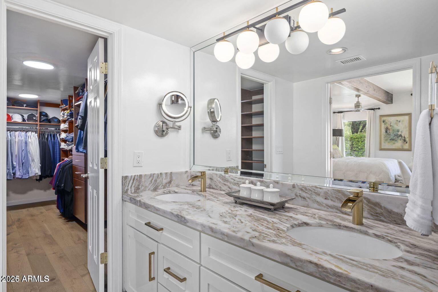 6198 North 28th Place Phoenix, AZ 85016 - Photo 12 of 21 a bathroom with double vanity sinks a vanity a lamp and a mirror