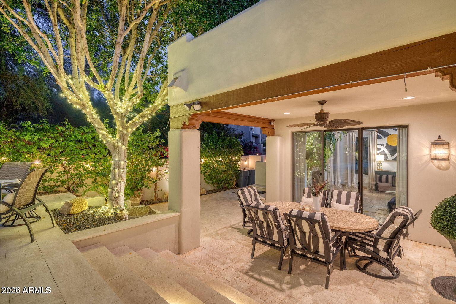 6198 North 28th Place Phoenix, AZ 85016 - Photo 14 of 21 a view of a patio with table and chairs and floor to ceiling window