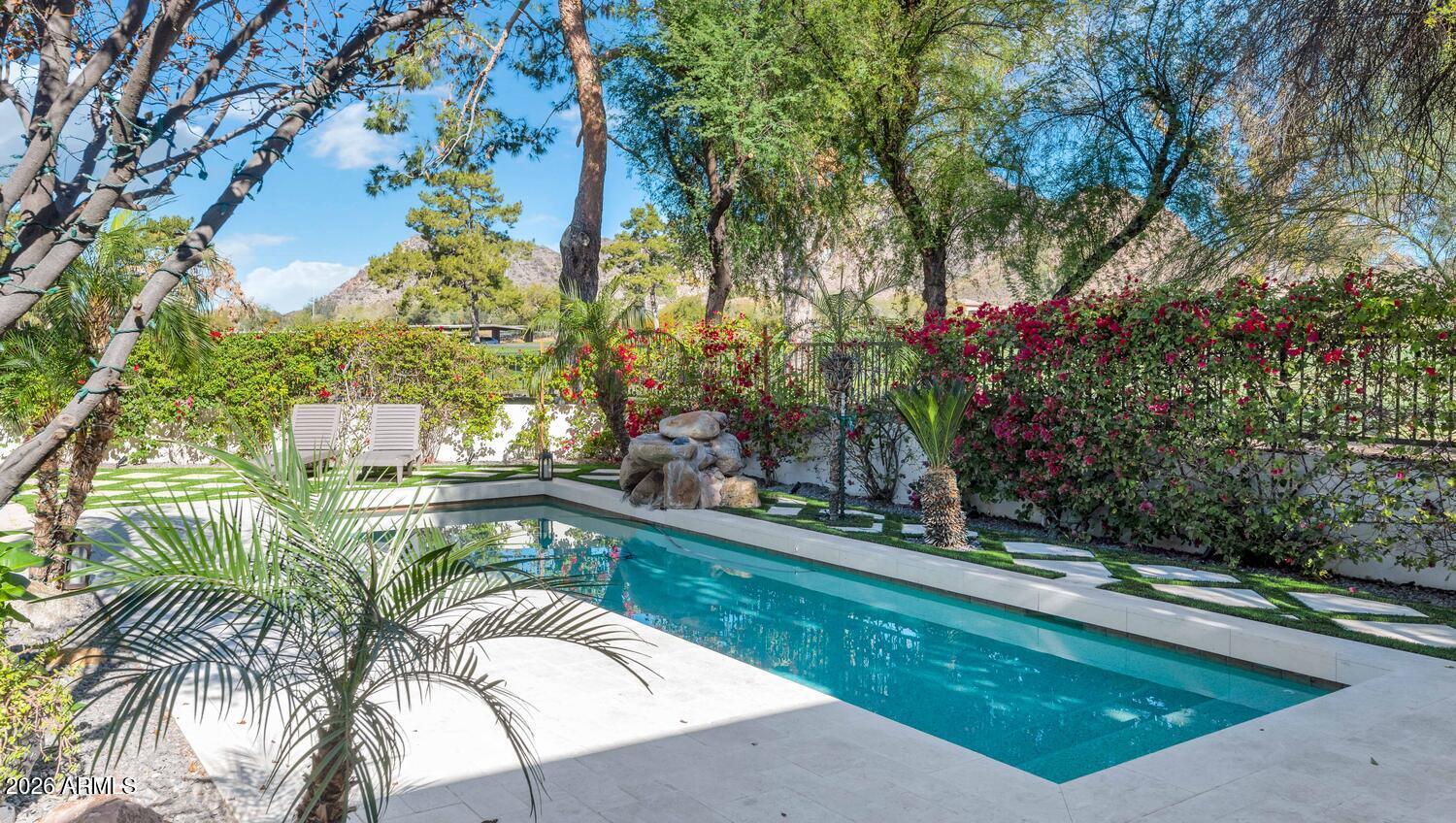 6198 North 28th Place Phoenix, AZ 85016 - Photo 24 of 33 a view of a swimming pool with a patio and a yard