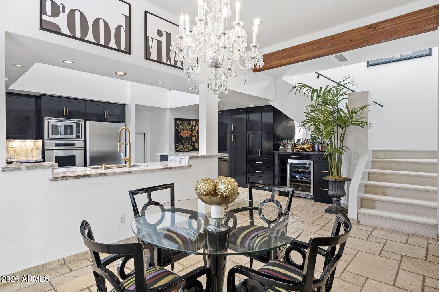 6198 North 28th Place Phoenix, AZ 85016 - Photo 6 of 21 a view of a dining room with furniture and a chandelier
