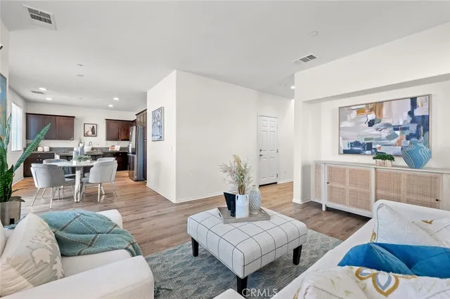 a view of an entryway with wooden floor and a livingroom