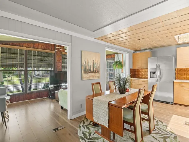 a dining room with furniture and wooden floor