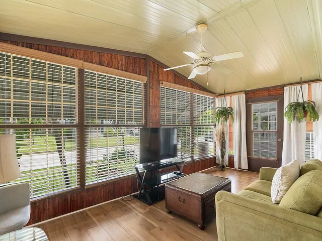 a living room with furniture and large windows