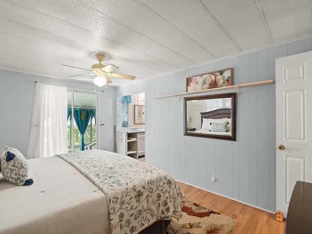 a bedroom with a large bed and a chandelier