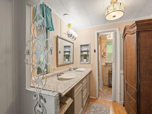 a bathroom with a sink a mirror and a shower