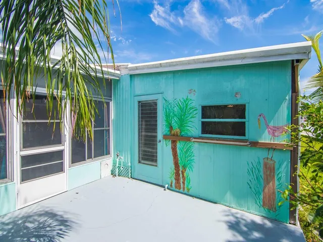 a backyard of a house with plants and outdoor seating