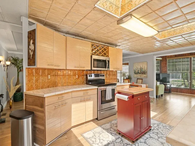 a kitchen with a stove a sink and a refrigerator