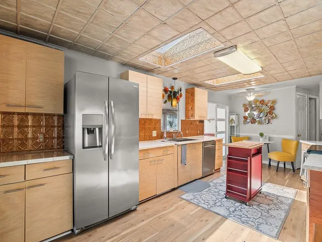 a kitchen with refrigerator and cabinets