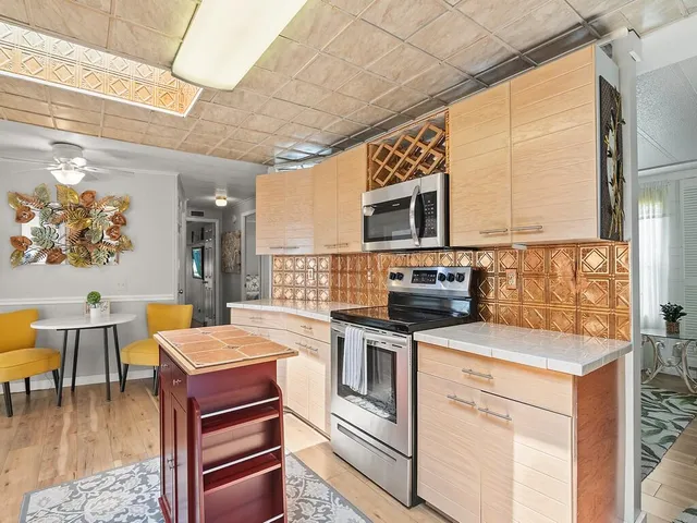 a kitchen with a stove a sink and a microwave