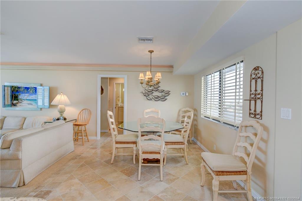 2375 Northeast Ocean Boulevard, Unit E405 Stuart, FL 34996 - Photo 14 of 58 a dining room with furniture and window