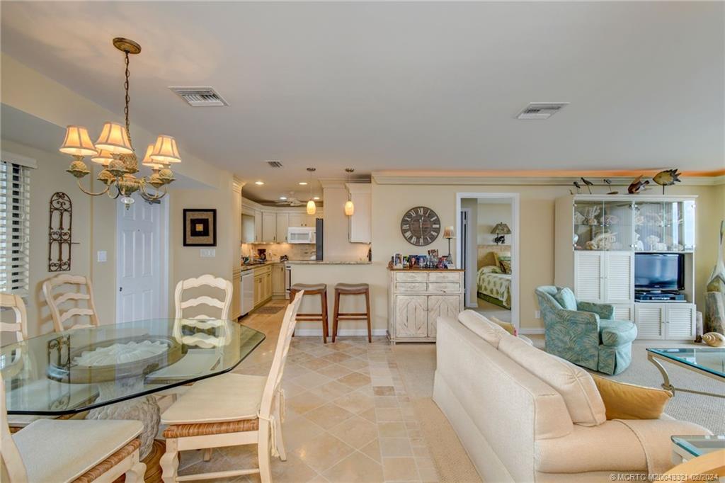 2375 Northeast Ocean Boulevard, Unit E405 Stuart, FL 34996 - Photo 15 of 58 a living room with furniture a chandelier and a chandelier