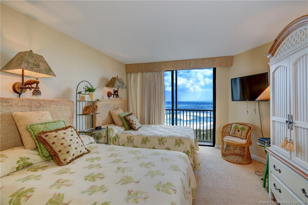 2375 Northeast Ocean Boulevard, Unit E405 Stuart, FL 34996 - Photo 25 of 58 a bedroom with a bed a couch and dresser