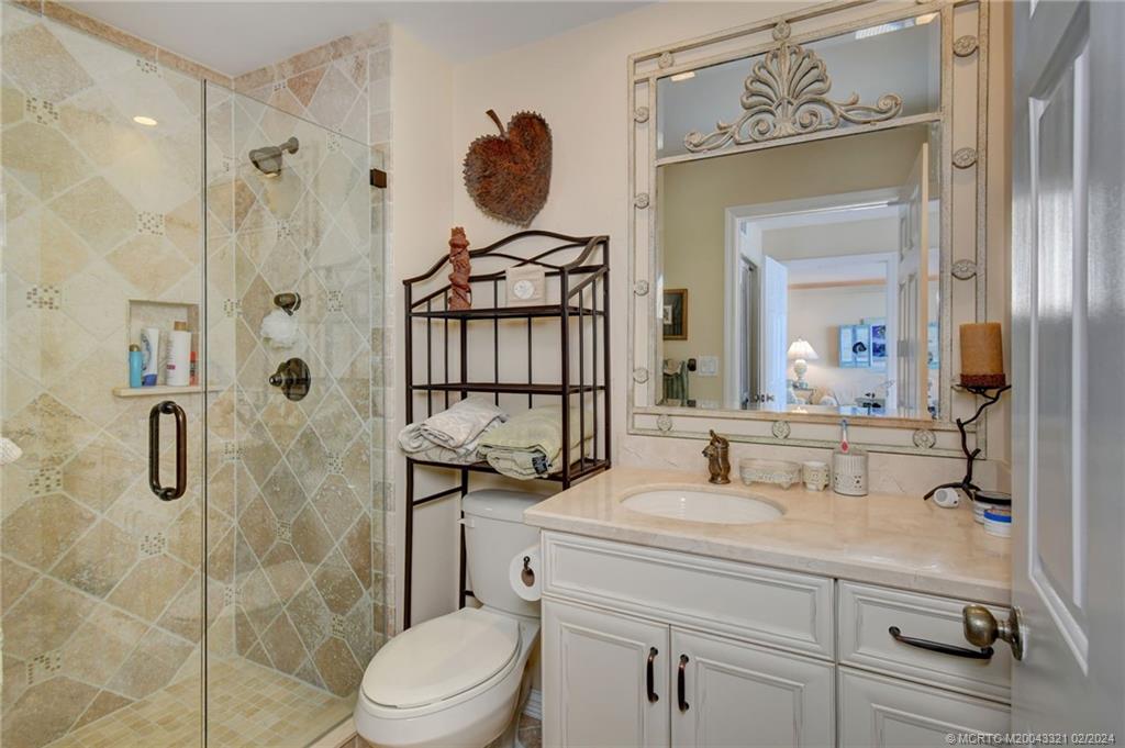 2375 Northeast Ocean Boulevard, Unit E405 Stuart, FL 34996 - Photo 26 of 58 a bathroom with a sink toilet and shower