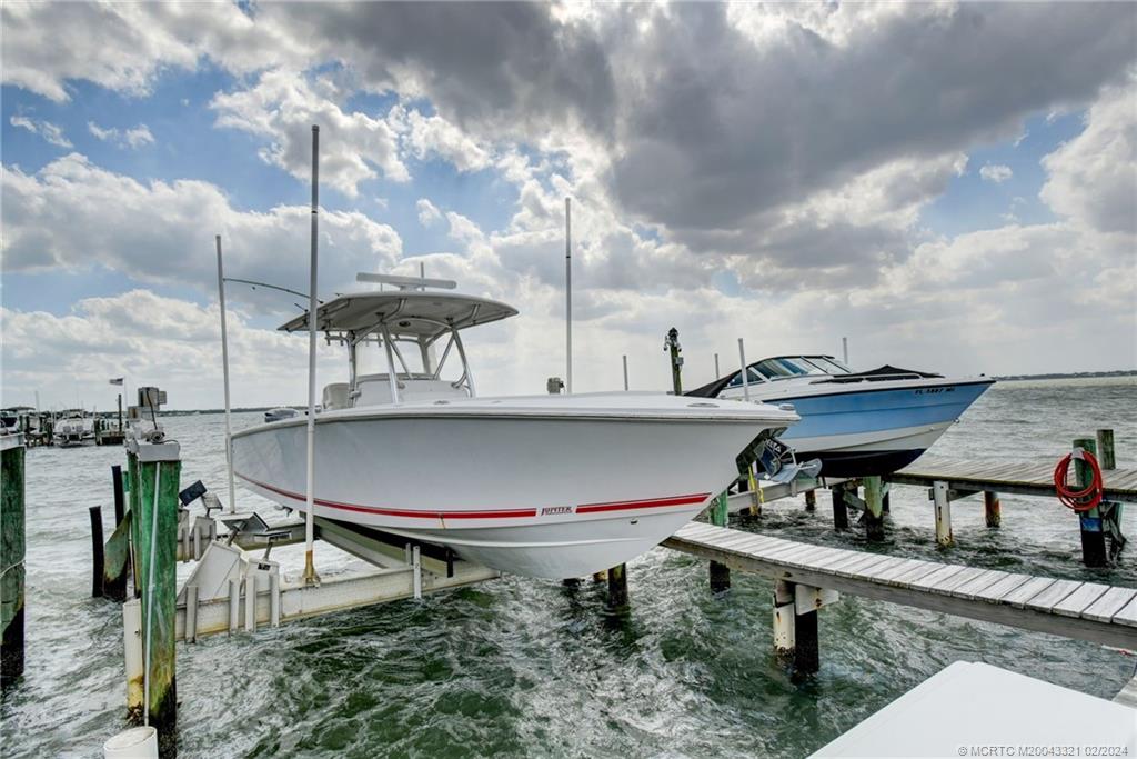 2375 Northeast Ocean Boulevard, Unit E405 Stuart, FL 34996 - Photo 45 of 58 a view of a balcony with chairs and wooden floor