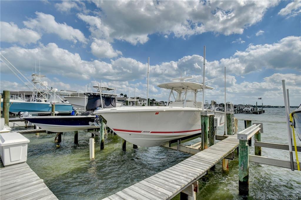 2375 Northeast Ocean Boulevard, Unit E405 Stuart, FL 34996 - Photo 46 of 58 a balcony with wooden floor and outdoor seating