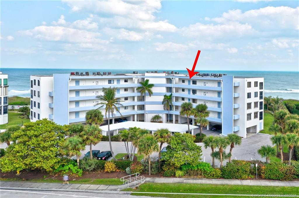 2375 Northeast Ocean Boulevard, Unit E405 Stuart, FL 34996 - Photo 47 of 58 a multi story building with trees in front of it