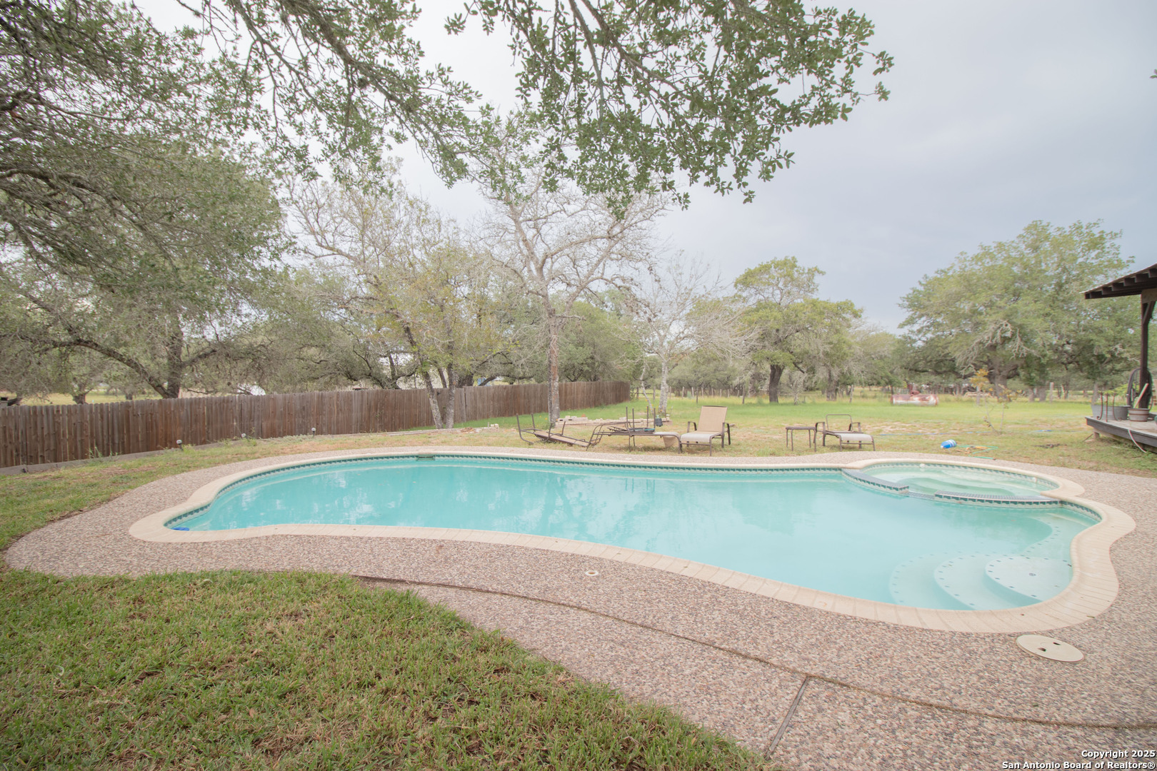 797 Killarney Road Floresville, TX 78114 - Photo 27 of 35 a view of a swimming pool with a yard