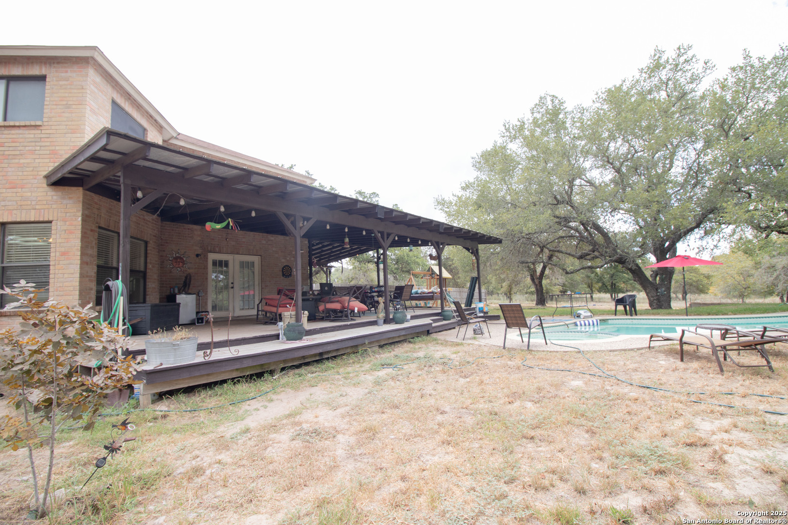 797 Killarney Road Floresville, TX 78114 - Photo 28 of 35 a view of a house with a patio