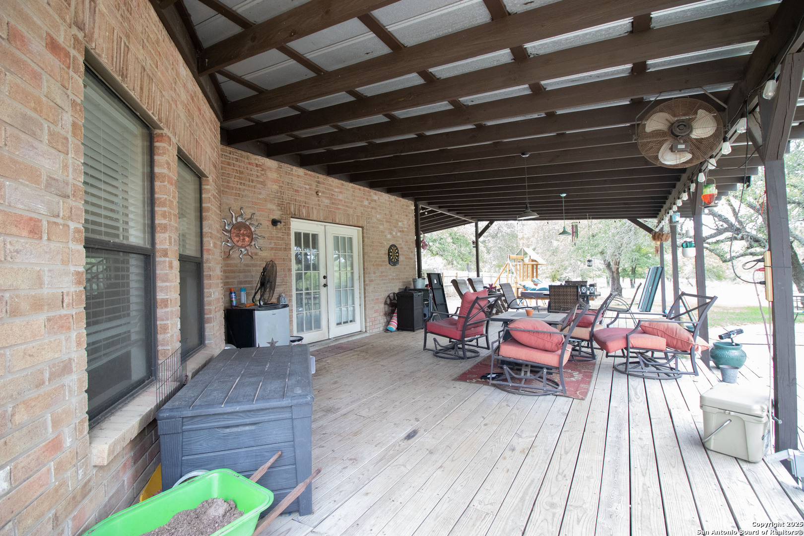 797 Killarney Road Floresville, TX 78114 - Photo 29 of 35 a view of a chairs and table in patio with wooden floor