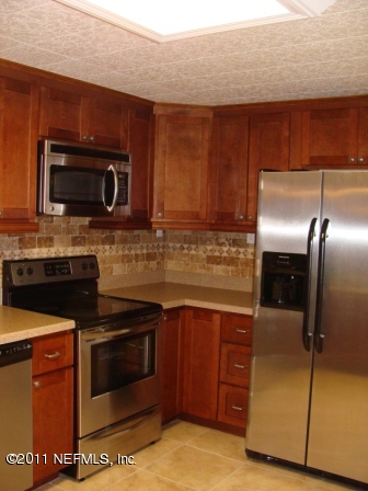 246 Alvis Road Jacksonville, FL 32220 - Photo 4 of 54 a kitchen with stainless steel appliances granite countertop a stove microwave and refrigerator