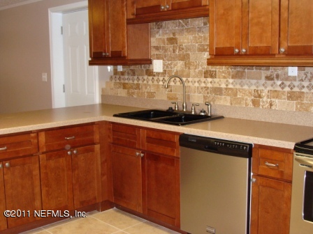 246 Alvis Road Jacksonville, FL 32220 - Photo 5 of 54 a kitchen with granite countertop cabinets and a sink