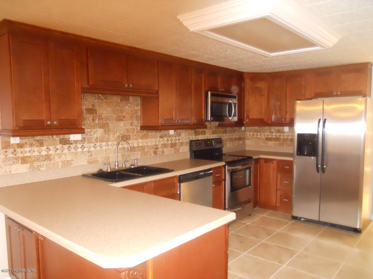 246 Alvis Road Jacksonville, FL 32220 - Photo 6 of 54 a kitchen with stainless steel appliances granite countertop a sink stove and refrigerator