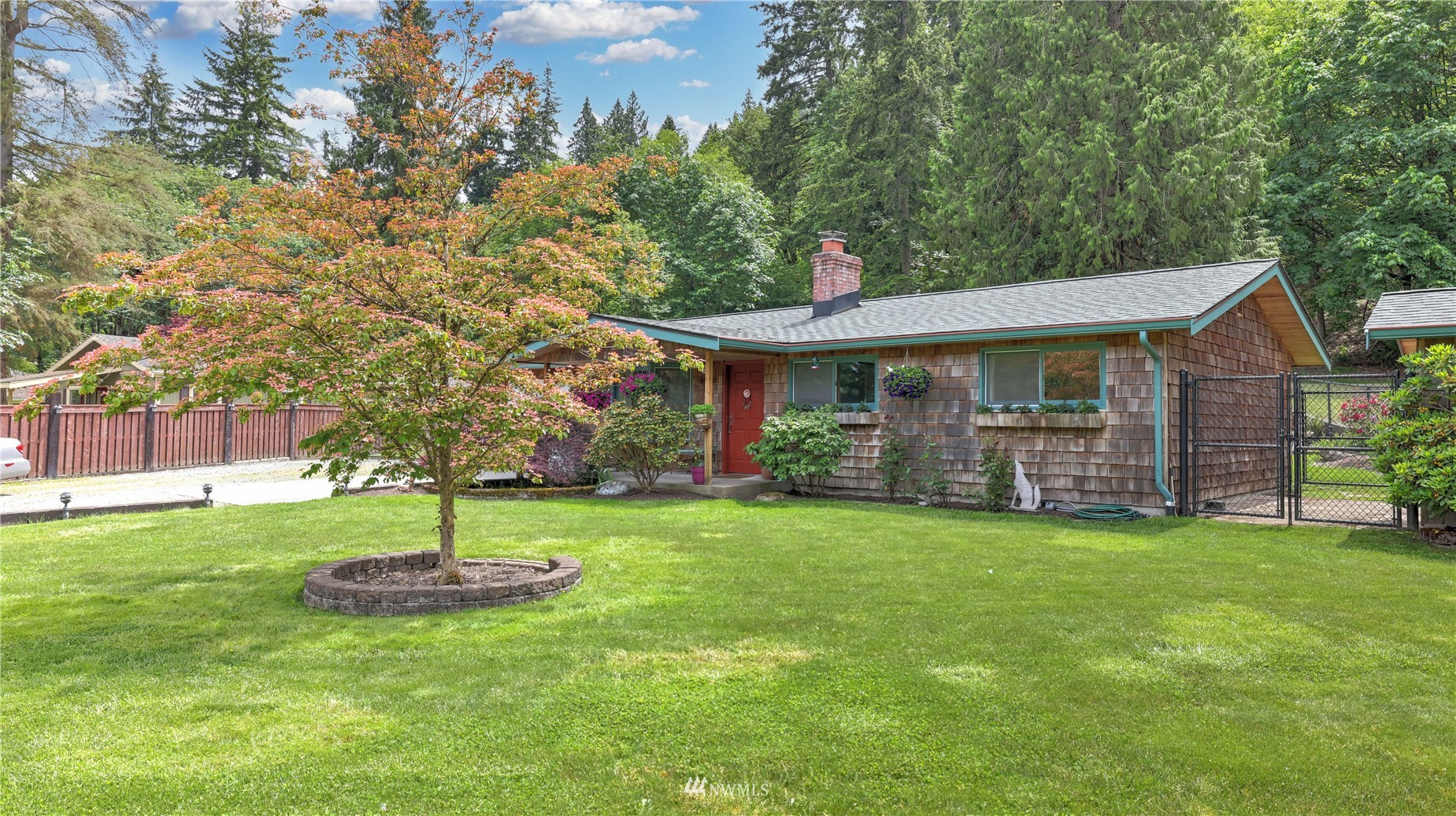 16819 Renton Issaquah Road Southeast Renton, WA 98059 - Photo 1 of 36 a front view of a house with a garden