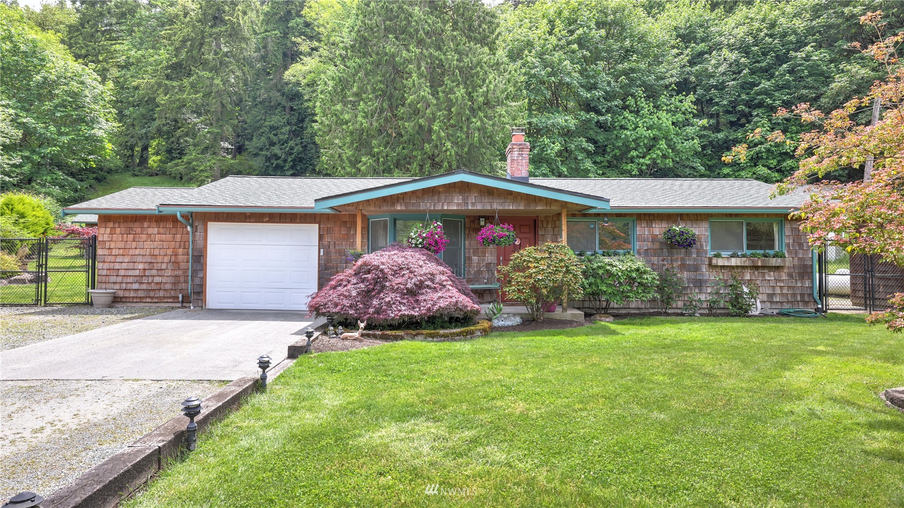 16819 Renton Issaquah Road Southeast Renton, WA 98059 - Photo 2 of 36 a front view of a house with a garden and yard