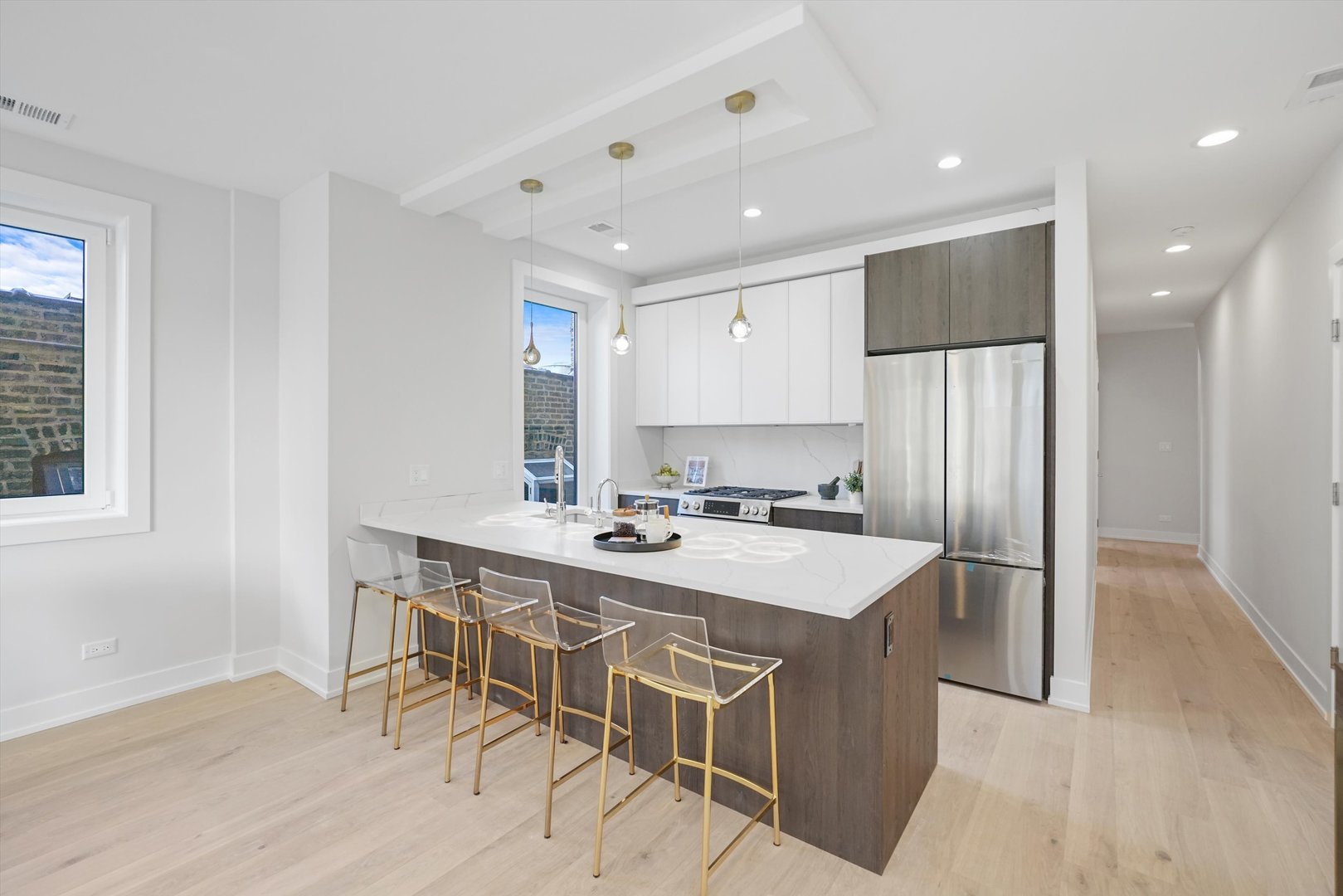 4647 North Clark Street, Unit 2 Chicago, IL 60640 - Photo 2 of 10 a kitchen with a table chairs refrigerator and cabinets