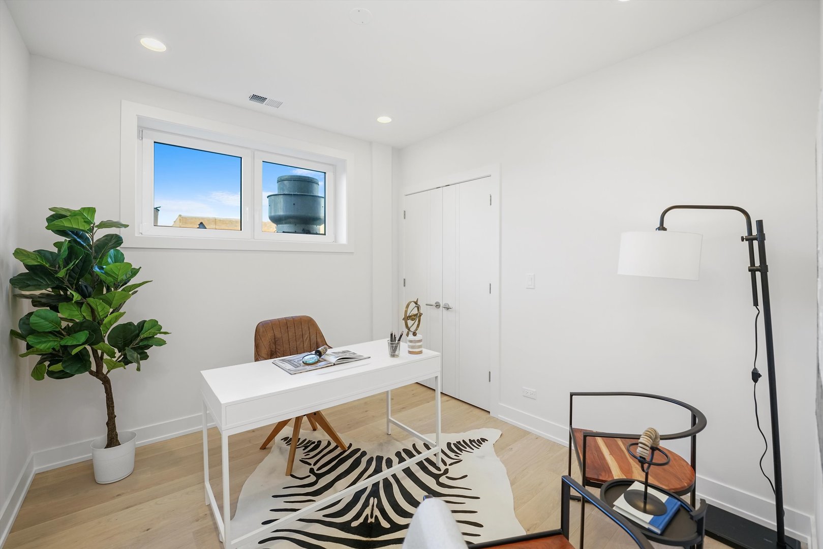 4647 North Clark Street, Unit 2 Chicago, IL 60640 - Photo 7 of 10 a bedroom with a bed and a potted plant