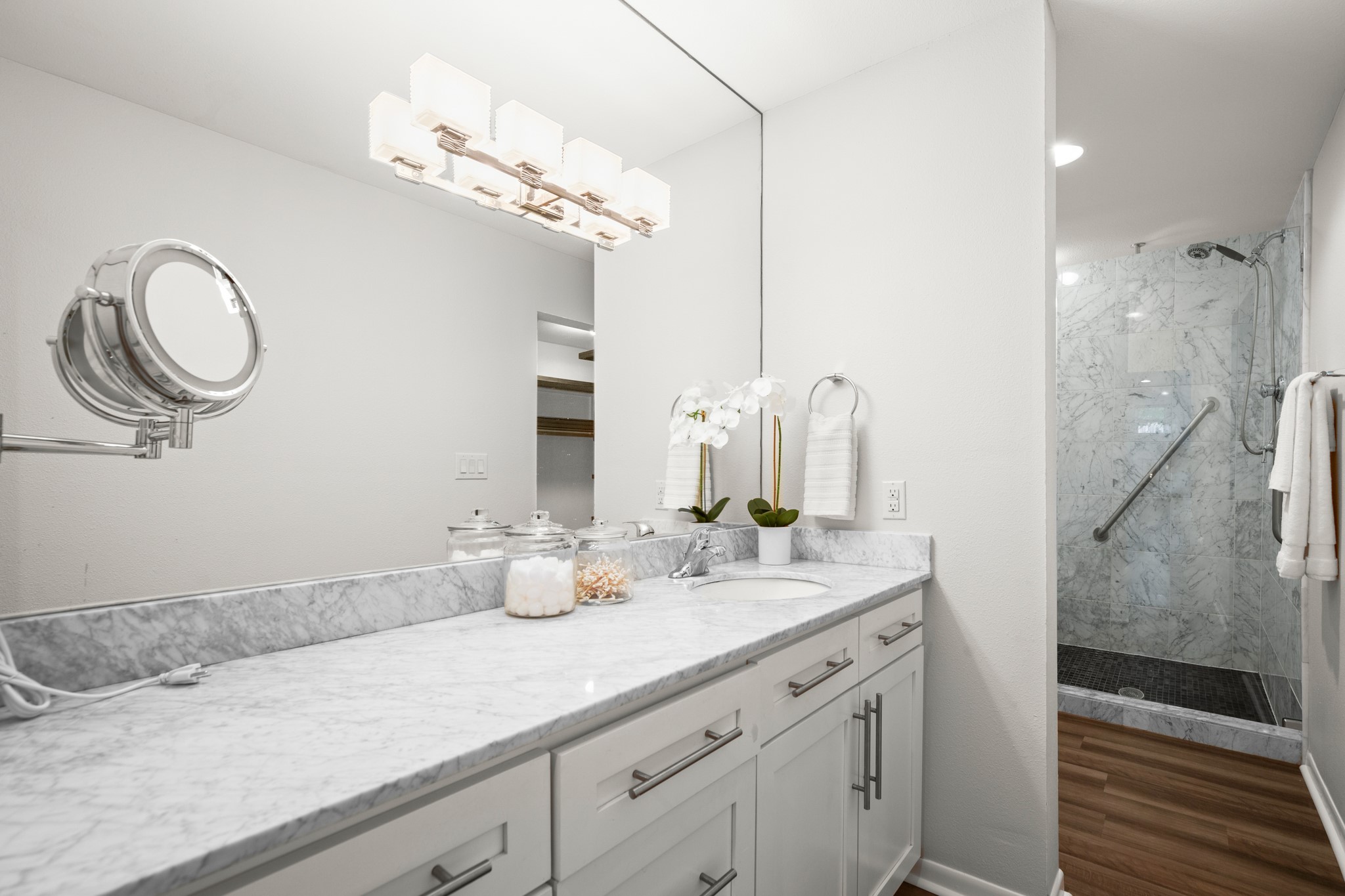 4116 Creek Ledge, Unit 108 Austin, TX 78731 - Photo 16 of 35 The primary ensuite bath is also updated with a contemporary vanity, Shaker-style cabinetry, and a walk-in shower.