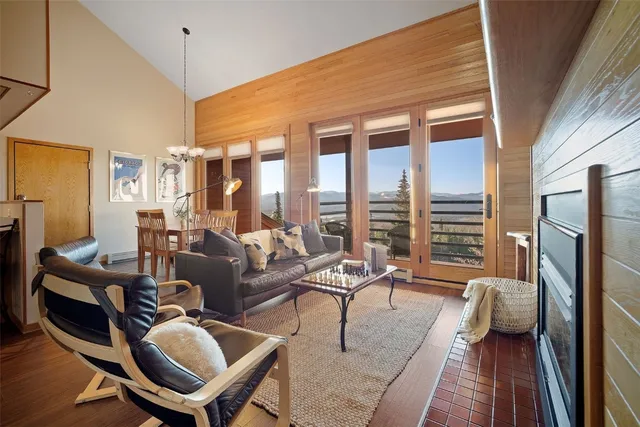 a living room with furniture fireplace and a large window