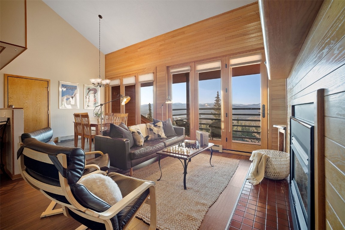91400 Ryan Gulch Road, Unit 91425 Silverthorne, CO 80498 - Photo 1 of 42 a living room with furniture fireplace and a large window