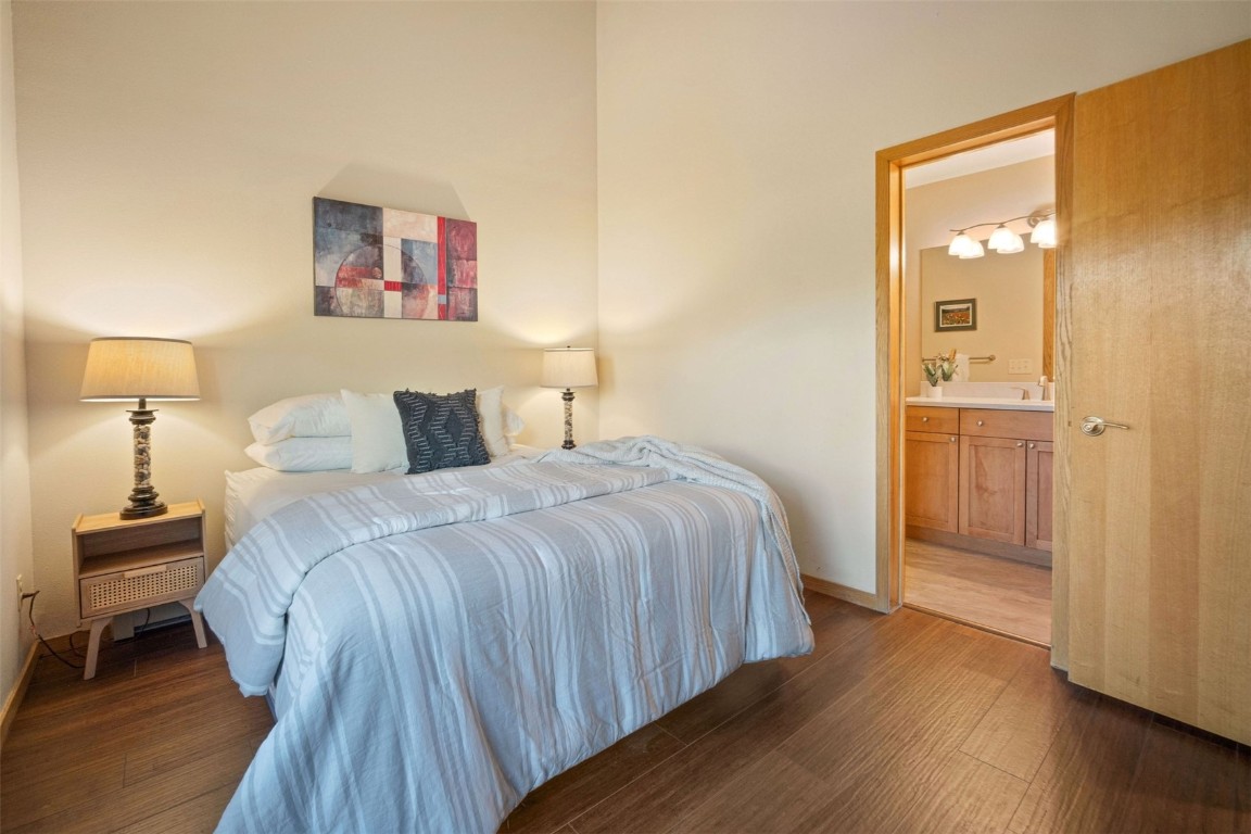91400 Ryan Gulch Road, Unit 91425 Silverthorne, CO 80498 - Photo 13 of 42 a bedroom with a bed and wooden floor