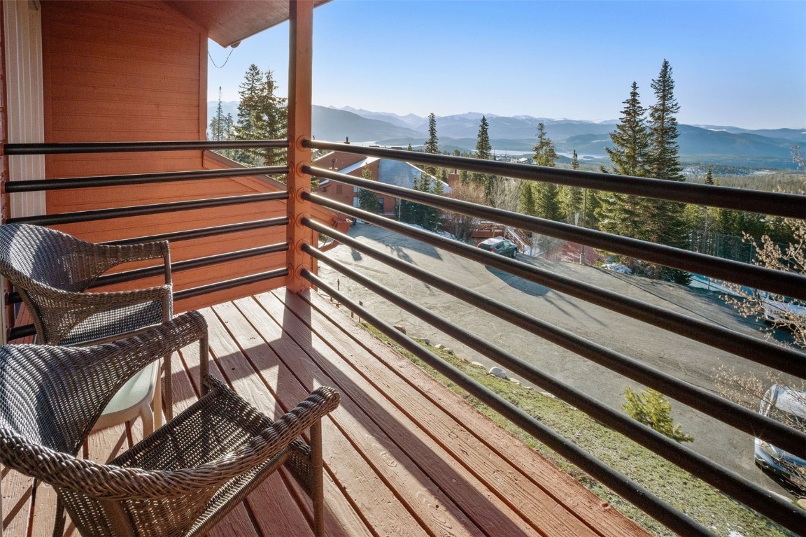 91400 Ryan Gulch Road, Unit 91425 Silverthorne, CO 80498 - Photo 2 of 42 a view of a balcony with wooden floor and outdoor seating