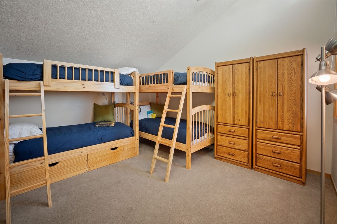 91400 Ryan Gulch Road, Unit 91425 Silverthorne, CO 80498 - Photo 22 of 42 a view of an empty room with furniture and staircase