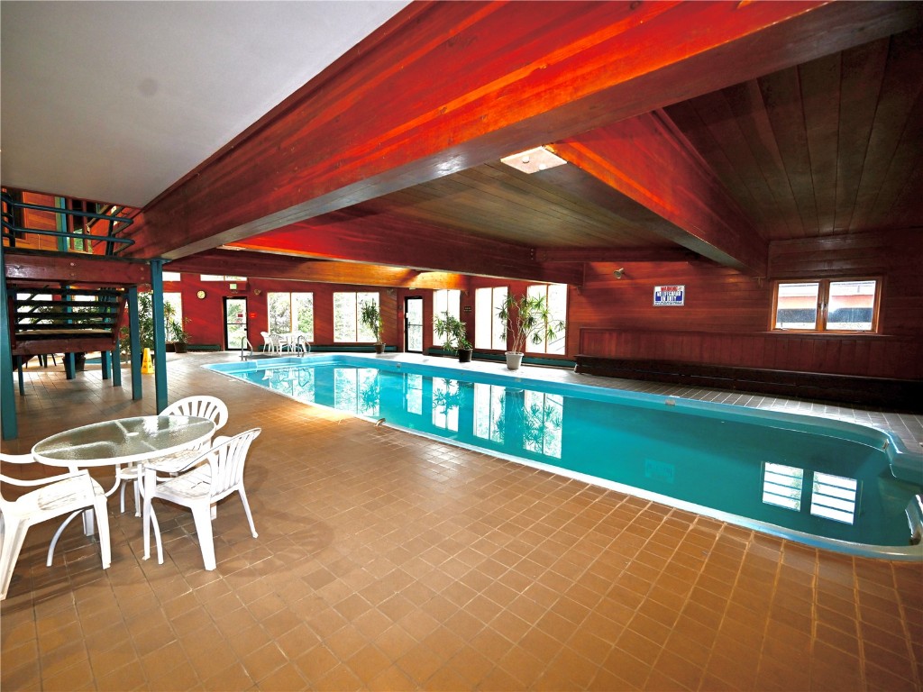 91400 Ryan Gulch Road, Unit 91425 Silverthorne, CO 80498 - Photo 35 of 42 a view of a porch with a table chairs and a backyard