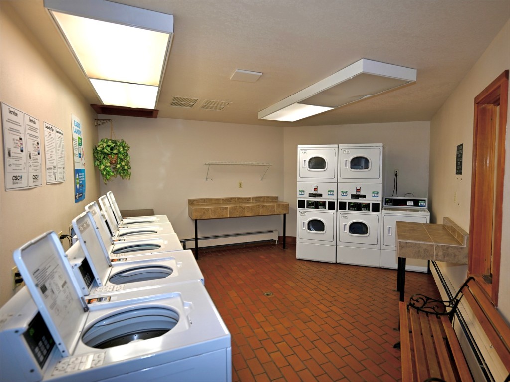 91400 Ryan Gulch Road, Unit 91425 Silverthorne, CO 80498 - Photo 38 of 42 a living room with furniture and a flat screen tv