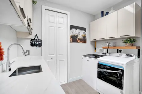 a kitchen with stainless steel appliances a white stove top oven and a refrigerator