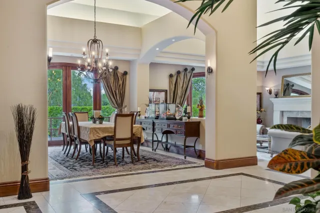 a view of a dining room with furniture and chandelier