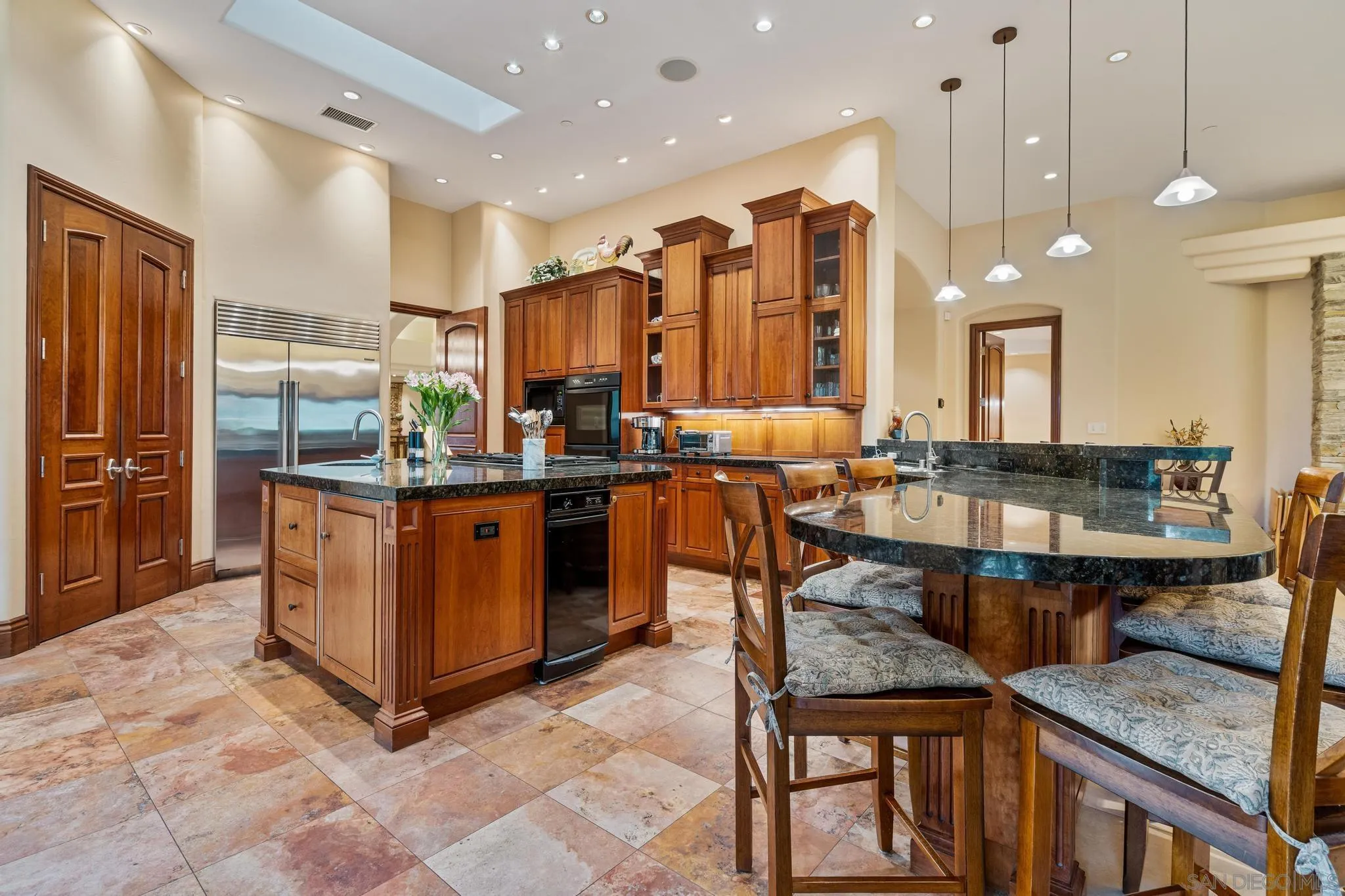 14380 Ciera Court Poway, CA 92064 - Photo 9 of 51 a kitchen with stainless steel appliances kitchen island granite countertop a table chairs and a refrigerator